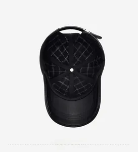 Detail of the black leather baseball cap interior featuring a white plaid fabric lining
