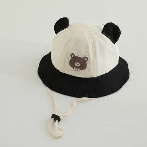 Close-up of baby sun hat featuring bear ears and embroidered cartoon bear detail