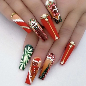 Detailed view of long coffin Christmas press-on nails with gingerbread and candy cane art