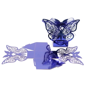 Detailed view of laser-cut butterfly candy box with metallic purple finish and ribbon