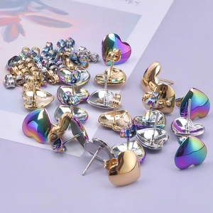 Flat lay of heart-shaped 304 stainless steel stud earrings in gold, silver and rainbow colors