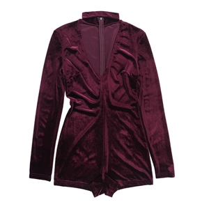 Detail of burgundy velvet bodysuit with deep V-neck and choker neck design