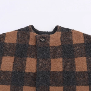 Brown and black oversized checkerboard knit coat featuring a round neck and resin button