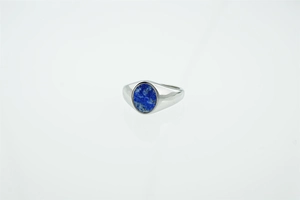 Close-up of vintage titanium steel ring with an oval turquoise stone and silver finish