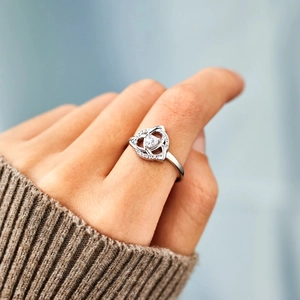 S925 sterling silver sister knot ring with sparkling heart zircon on a model's hand