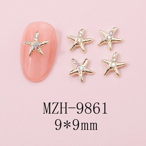 Macro shot of 9x9mm gold starfish nail charms with iridescent gems on pink base
