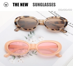 Detail of retro oval sunglasses in leopard print and cream pink on a vintage magazine