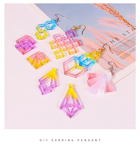 Macro view of gradient resin earring pendants in geometric heart and teardrop shapes