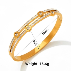 Detail view of gold-plated bangle with sparkling pavé crystals and size measurements