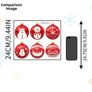 Size comparison of Christmas ball stickers on backing paper beside a mobile phone