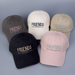 Detailed view of cotton baseball caps in multiple colors with colorful embroidery