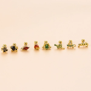 Golden animal cartilage studs set with colorful zircons including snake and gecko shapes