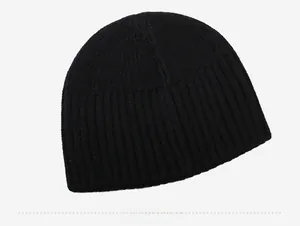 Close-up of black ribbed knit beanie showing dense texture and high-quality stitching