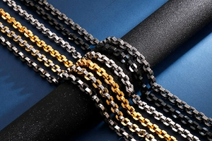 Detailed close-up of colorful stainless steel hip hop box chains in gold, silver and black