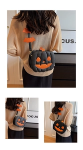 Detail view of pumpkin-shaped crossbody bag with black leather and orange bat decor
