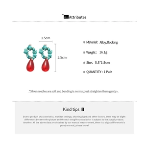 Close-up of blue stone beads and red water drop pendants on bohemian style earrings