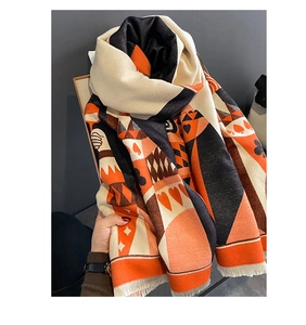 Detail of cashmere-feel scarf with poker card heart pattern and fringe tassels