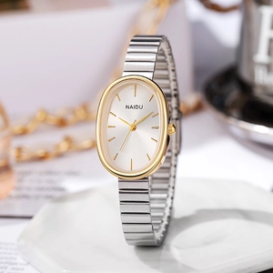 Detailed view of an elegant silver and gold oval quartz watch with metallic strap