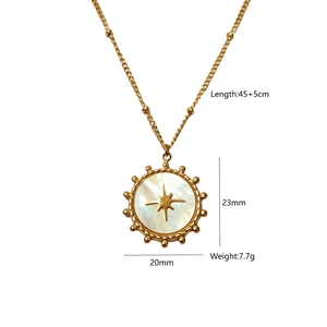 Detailed view of star-engraved gold pendant with white shell inlay and specifications