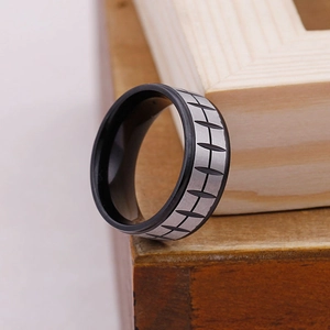 Macro detail of men's tire tread pattern ring with silver finish and black inner plating
