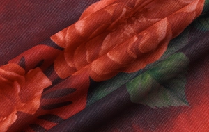 Dettaglio del tessuto a rete trasparente con stampa floreale rossa e arancione