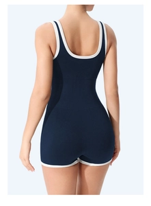 Deep blue ribbed bodysuit with white contrast piping and open back detail for yoga