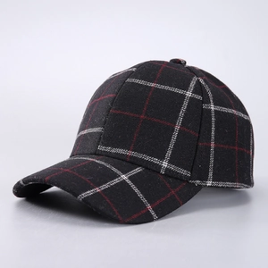 Detail of red and black plaid pattern fabric on a thick winter baseball cap