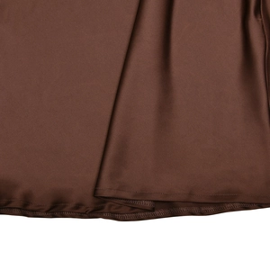 Close-up of the stitching detail and brown satin fabric texture on the dress hem