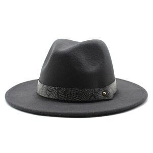 Close-up of dark grey wool fedora featuring a luxury snakeskin leather band and gold stud