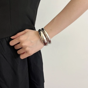 Minimalist silver double-layered open bangle with polished metallic irregular finish