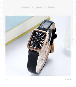 Macro shot of rectangular rose gold watch with black leather strap and Roman numerals