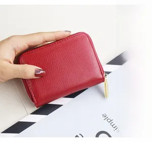 Macro detail of red litchi texture card holder with durable gold zipper closure