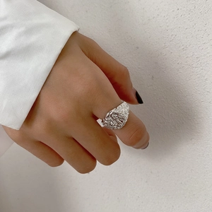 Detail of S925 sterling silver ring with unique irregular hammered lava texture finish