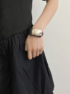 Silver double-layer wide open cuff bracelet shown on model with metallic finish