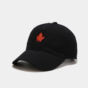 Close-up of maple leaf embroidery on black cotton baseball cap with fine stitching