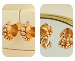Detailed macro view of 18K gold C-shaped hoop earrings with inlaid oval zircon stones