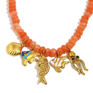 Handmade beaded necklace with 18K gold fish and octopus ocean charms on orange beads