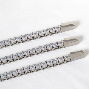 Macro detail of silver tennis bracelets with square zircons and secure box clasp closure