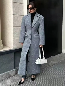 Detail of grey wool coat with single-breasted buttons and structured shoulders