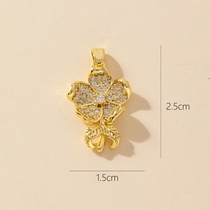 Detailed view of gold flower pendant with zircons showing dimensions 2.5cm by 1.5cm
