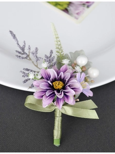 Macro shot of handmade purple silk boutonniere with white flowers and elegant pearls