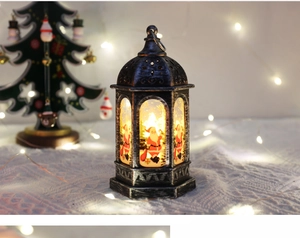 Detail view of retro Christmas lantern featuring Santa Claus pattern and warm LED glow