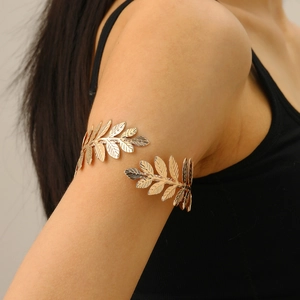 Close-up of golden laurel leaf arm cuff featuring detailed leaf veins on upper arm