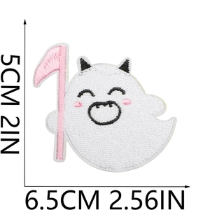 Close-up of white ghost embroidery patch with pink scythe and size measurements