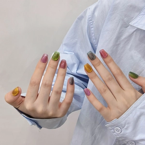 Handmade cat eye press-on nails in colorful aurora shades with a square oval shape