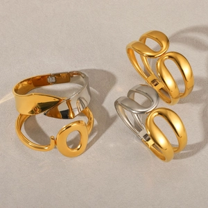 Polished 18k gold and silver spring cuff bracelets with minimalist cutout design