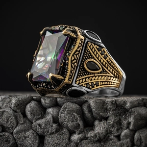 Macro view of vintage copper ring featuring colorful square gemstone and gold relief