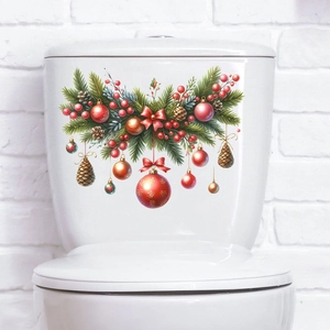 Detailed Christmas tree ball and pine branch sticker on a white ceramic toilet tank surface