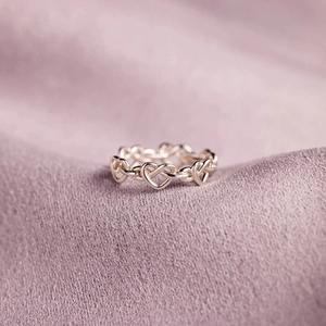 Detailed macro view of S925 sterling silver ring with interlocking hollow heart shapes