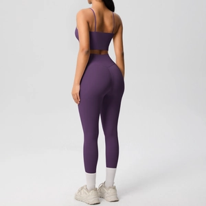 Rear view of deep purple tight yoga set showing back details and high waist leggings